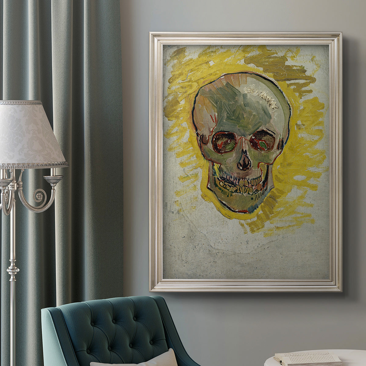 Expressive skull study painting by Vincent van Gogh in an ornate champagne frame displayed in a neutral interior setting.