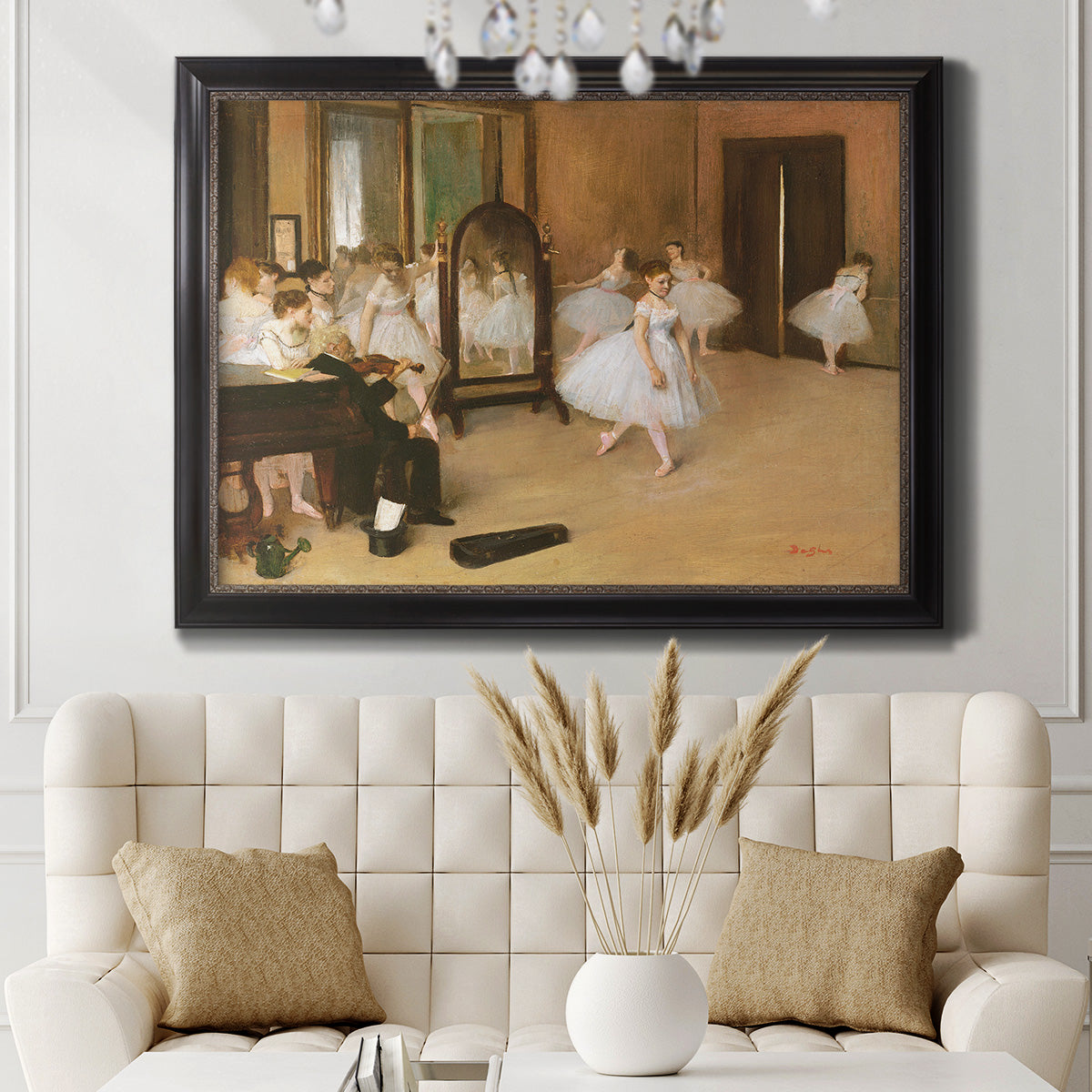 Impressionist dance class interior scene by Edgar Degas in an ornate black frame with gilded inner detail displayed in a neutral-toned interior setting.