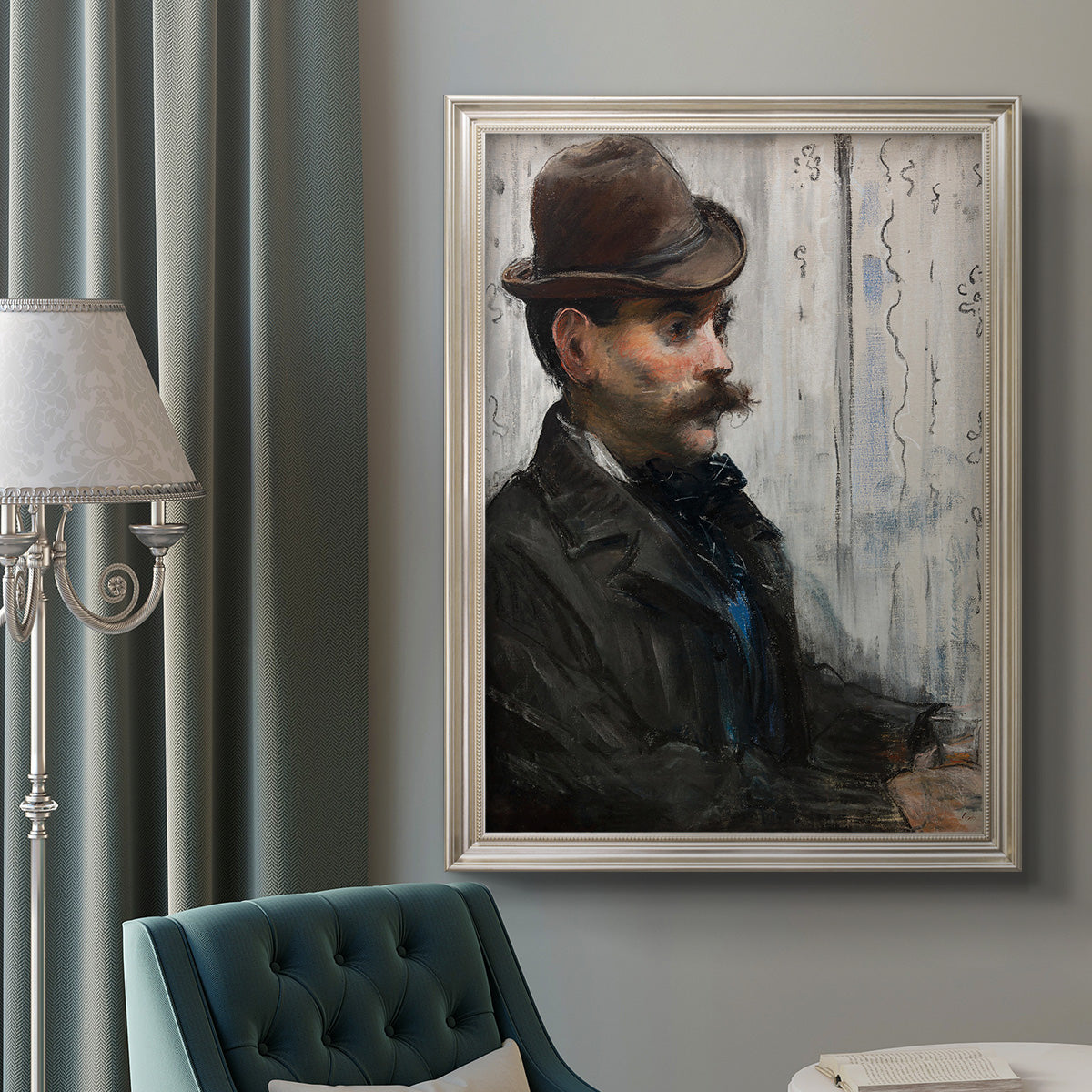 Impressionist portrait of a seated man by Édouard Manet in an ornate champagne frame displayed in a neutral interior setting.