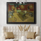 Impressionist interior of a night café by Vincent van Gogh in an ornate black frame with gilded inner detail displayed in a neutral-toned interior setting.