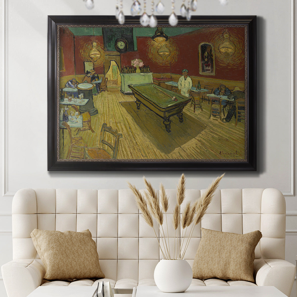 Impressionist interior of a night café by Vincent van Gogh in an ornate black frame with gilded inner detail displayed in a neutral-toned interior setting.