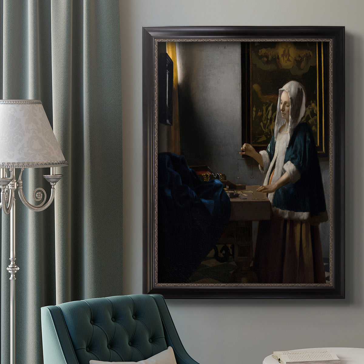 Quiet interior genre scene of a woman with scales by Johannes Vermeer in an ornate black frame with gilded inner detail displayed in a neutral interior setting.