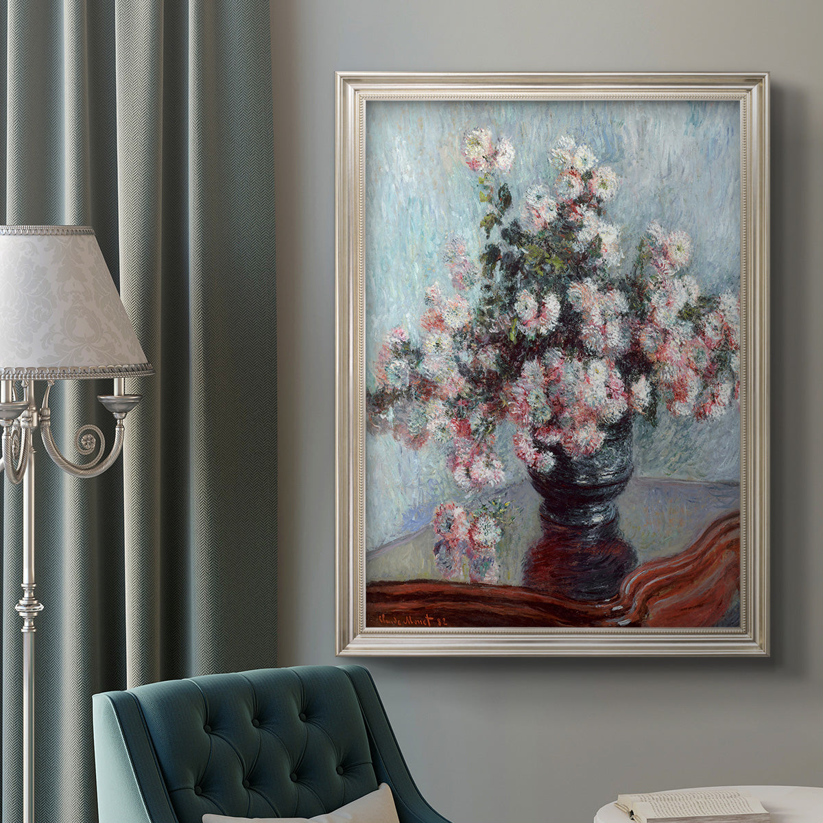 Impressionist chrysanthemum floral painting by Claude Monet in an ornate champagne frame displayed in a neutral interior setting.
