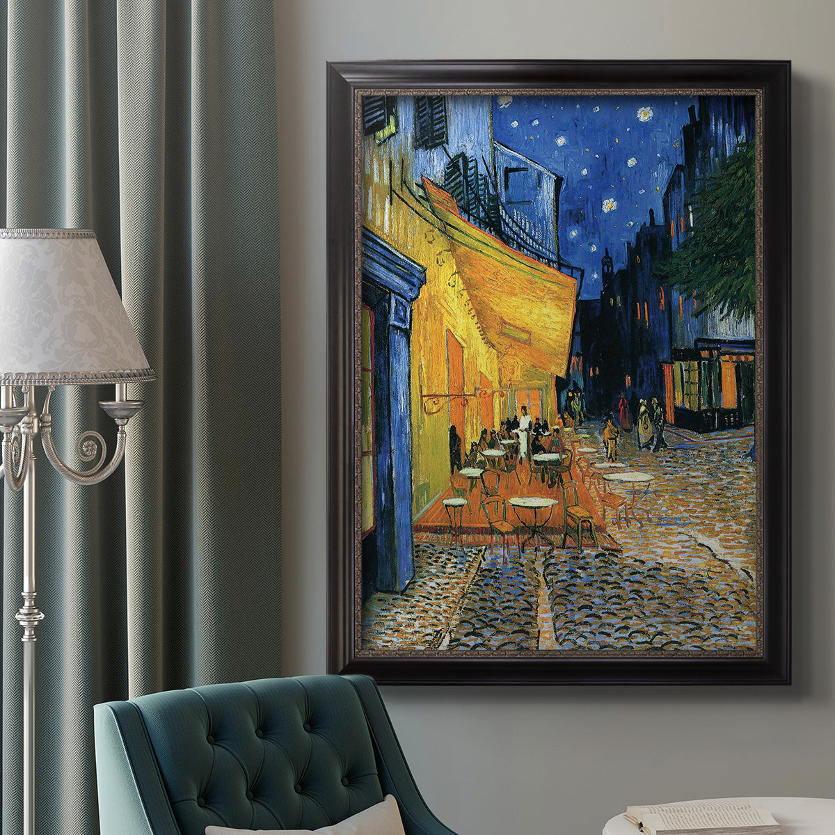 Impressionist night café street scene by Vincent van Gogh in an ornate black frame with gilded inner detail displayed in a neutral interior setting.