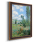 Impressionist pastoral landscape with poppy fields by Claude Monet printed on canvas in an ornate bronzed mahogany wood frame with a vertical orientation.