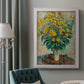Impressionist floral painting of artichoke flowers by Claude Monet in an ornate weathered white frame displayed in a neutral interior setting.