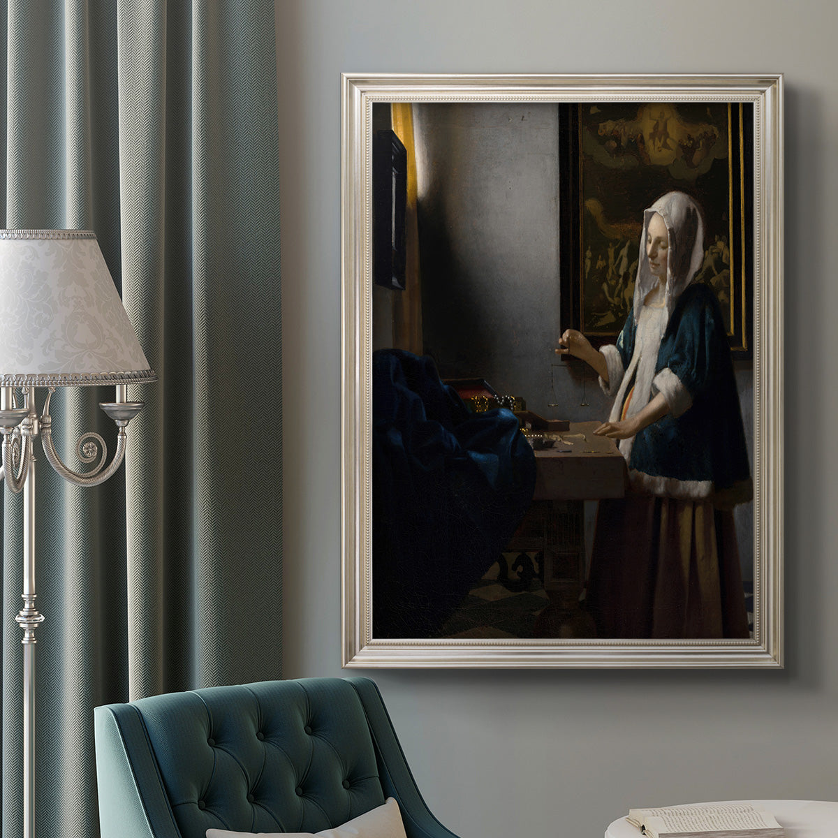 Quiet interior genre scene of a woman with scales by Johannes Vermeer in an ornate champagne frame displayed in a neutral interior setting.