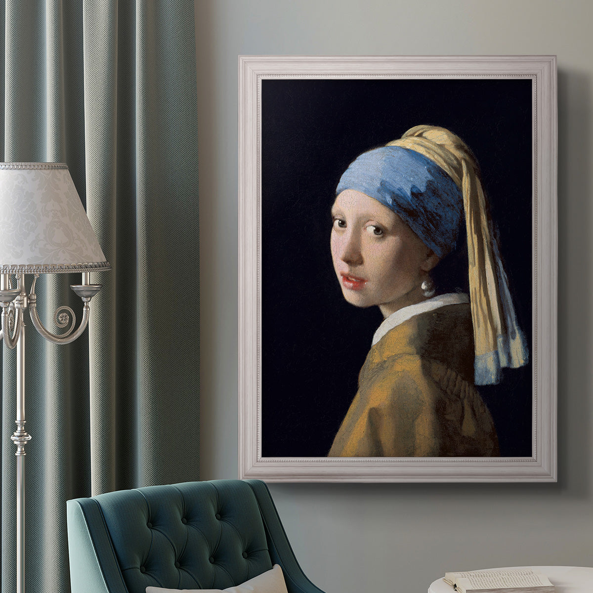 Iconic portrait of a girl wearing a pearl earring by Johannes Vermeer in an ornate weathered white frame displayed in a neutral interior setting.