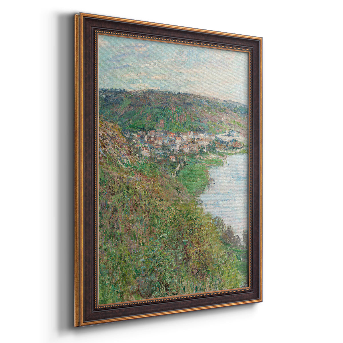 Impressionist landscape view of Vétheuil by Claude Monet printed on canvas in an ornate bronzed mahogany wood frame with a vertical orientation.