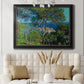 Impressionist Mediterranean coastal landscape by Claude Monet in an ornate black frame with gilded inner detail displayed in a neutral-toned interior setting.