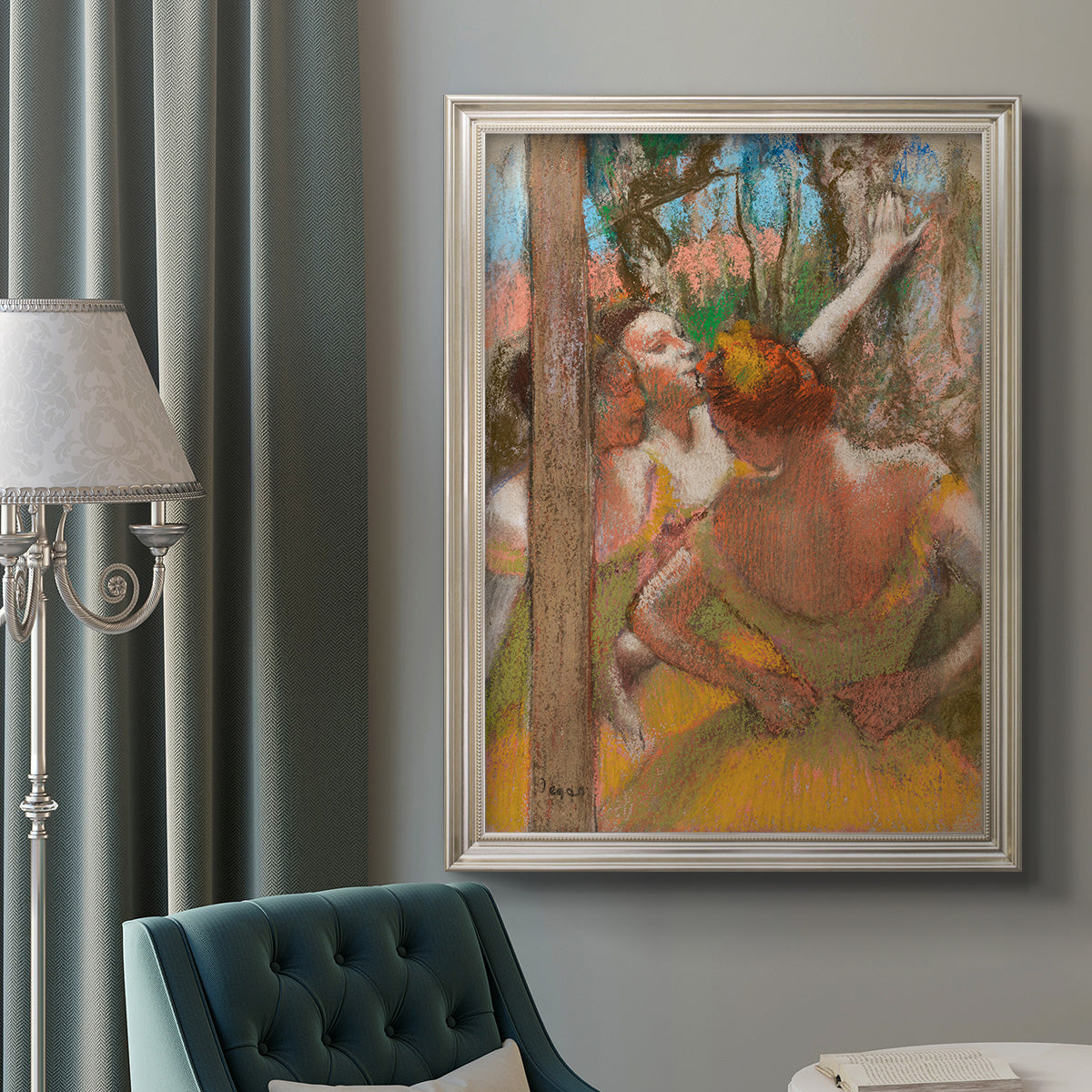 Impressionist ballet dancer composition by Edgar Degas in an ornate champagne frame displayed in a neutral interior setting.