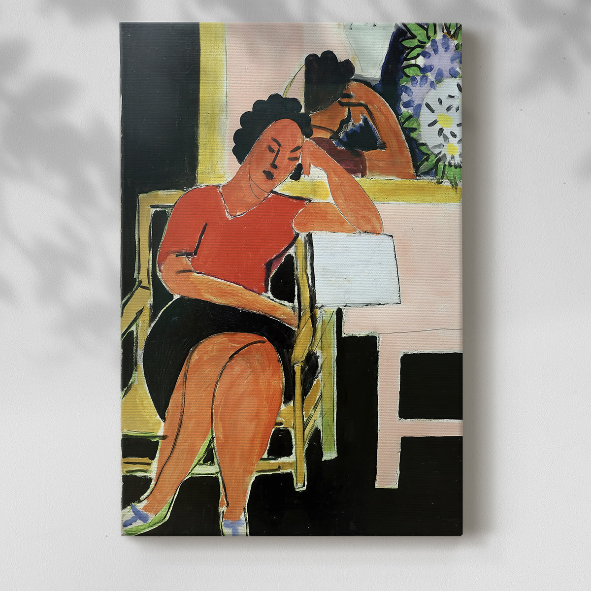 Canvas art print of a seated figure with a book in strong contrast and simple forms with a soft shadow on a white background.