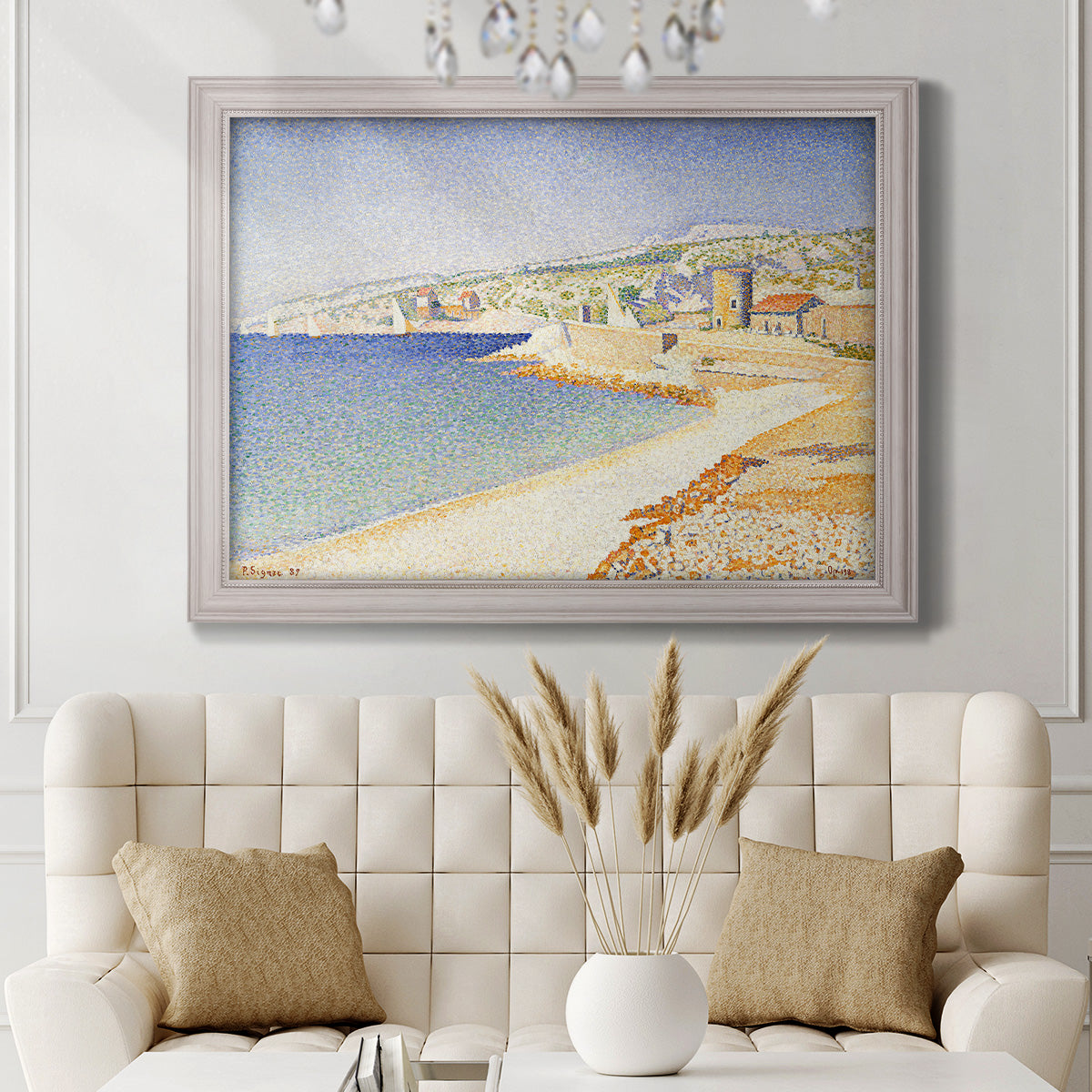 Impressionist Mediterranean jetty seascape by Paul Signac in an ornate weathered white frame displayed in a neutral-toned interior setting.