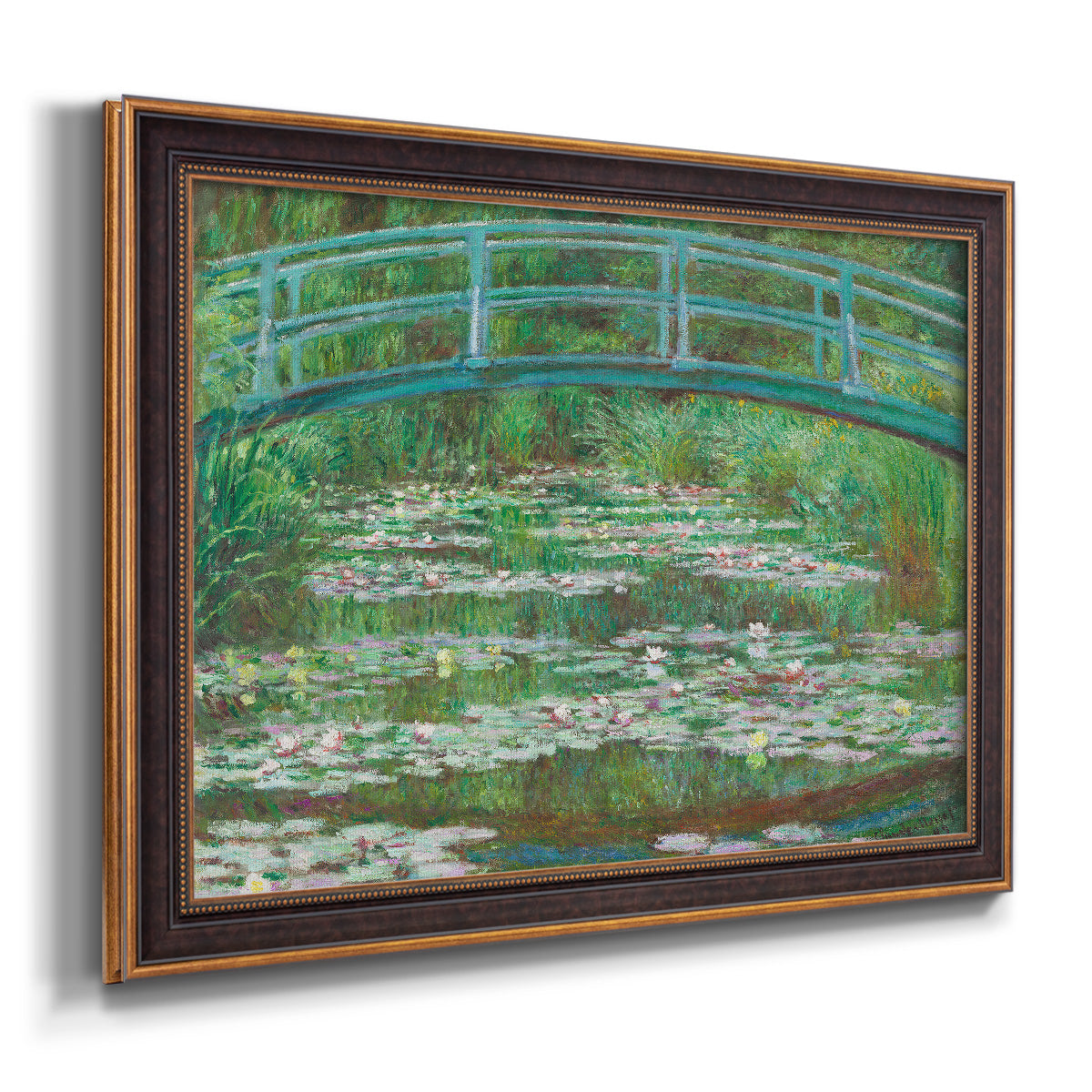 Impressionist garden scene with Japanese bridge and water lilies by Claude Monet printed on canvas in an ornate bronzed mahogany wood frame.