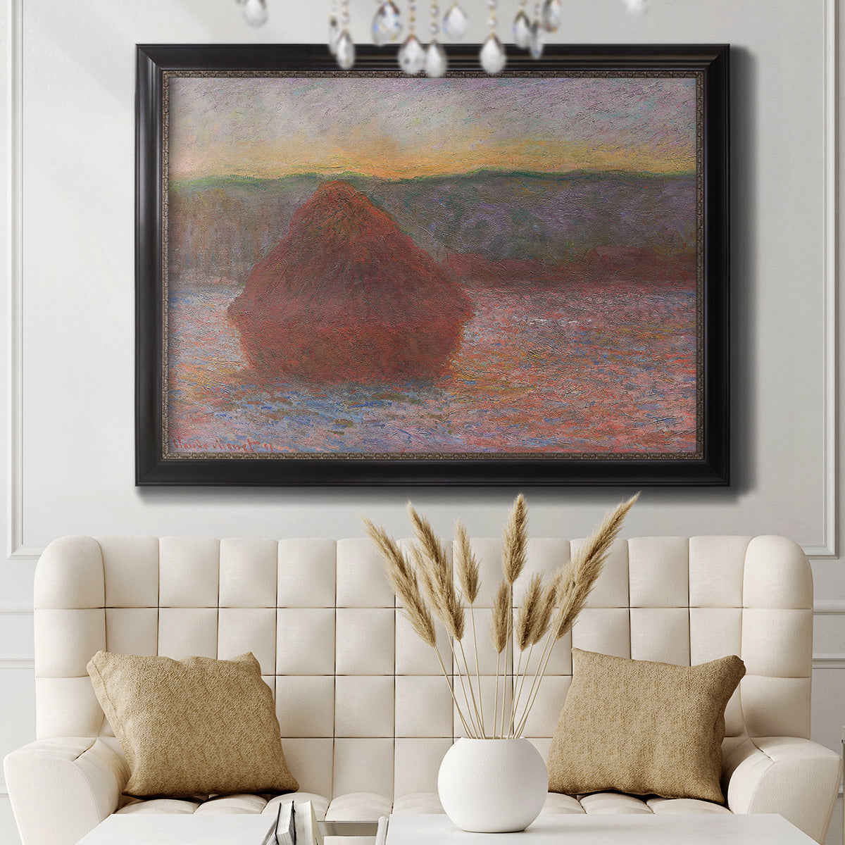 Impressionist haystack sunset scene in winter by Claude Monet in an ornate black frame with gilded inner detail displayed in a neutral-toned interior setting.