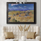 Impressionist wheat harvest scene by Vincent van Gogh in an ornate black frame with gilded inner detail displayed in a neutral-toned interior setting.