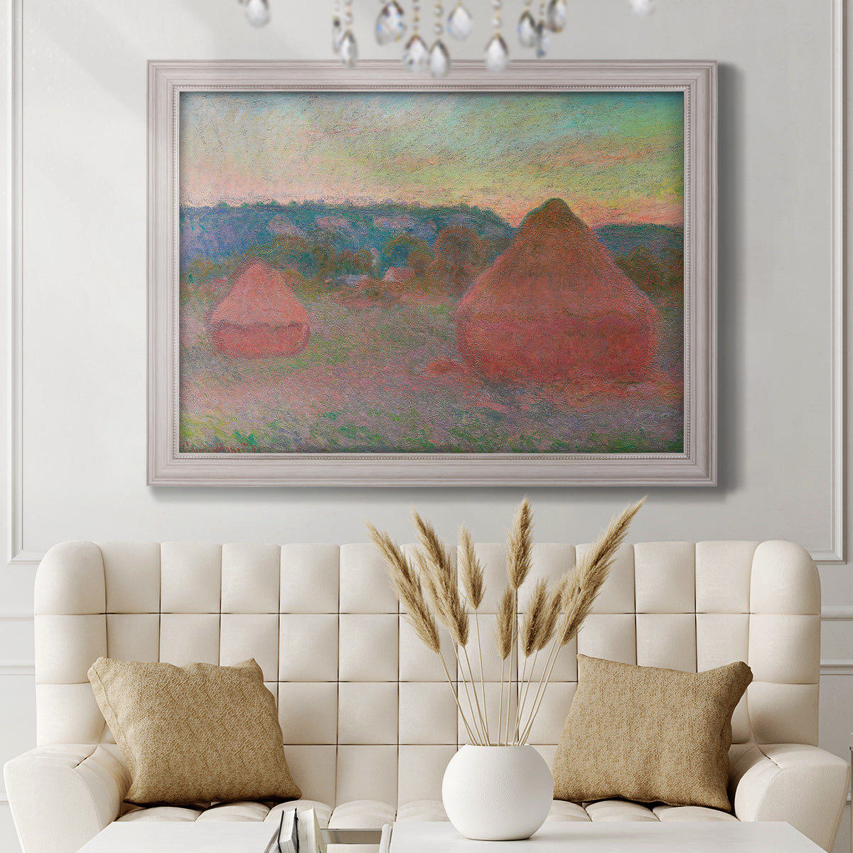 Impressionist haystack series landscape by Claude Monet in an ornate weathered white frame displayed in a neutral-toned interior setting.