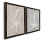 Angled view of a set of two black barnwood framed canvas prints featuring two rustic minimalist botanical prints featuring white botanical silhouettes on softly weathered neutral backgrounds.