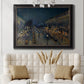 Impressionist nighttime Paris street scene by Camille Pissarro in an ornate black frame with gilded inner detail displayed in a neutral-toned interior setting.