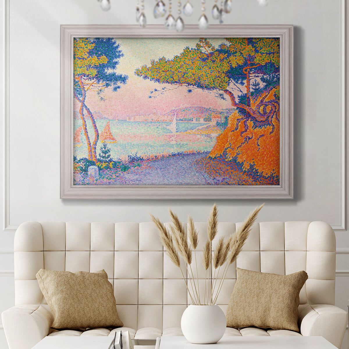 Pointillist coastal seascape by Paul Signac in an ornate weathered white frame displayed in a neutral-toned interior setting.
