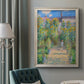 Impressionist garden landscape painting by Claude Monet in an ornate champagne frame displayed in a neutral interior setting.