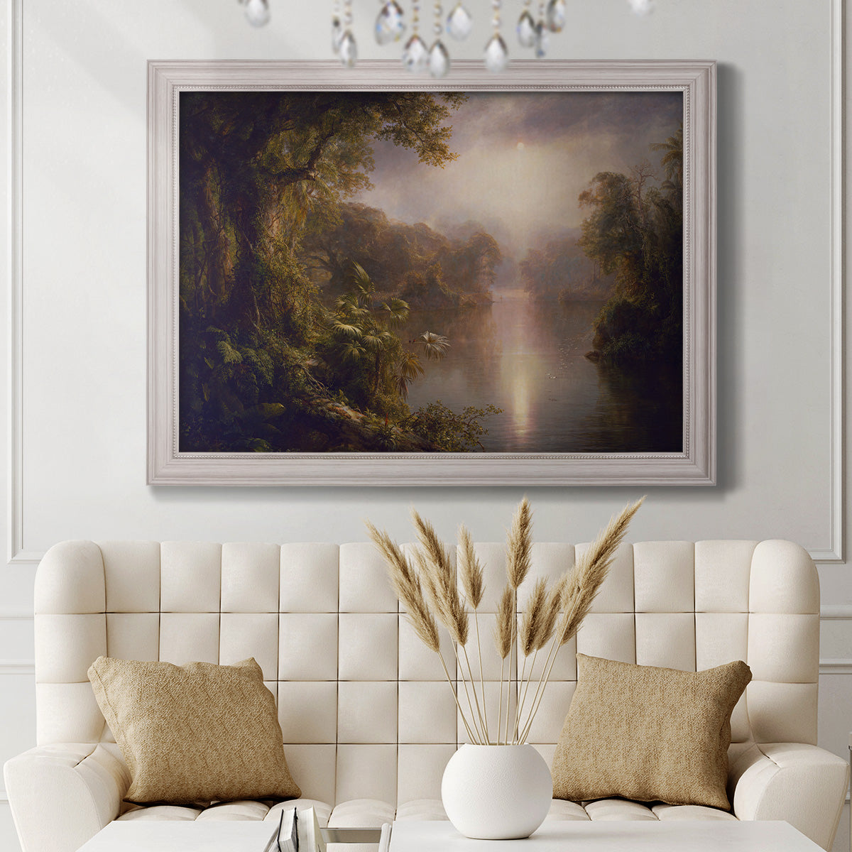 Luminous romantic landscape painting by Frederic Edwin Church in an ornate weathered white frame displayed in a neutral-toned interior setting.