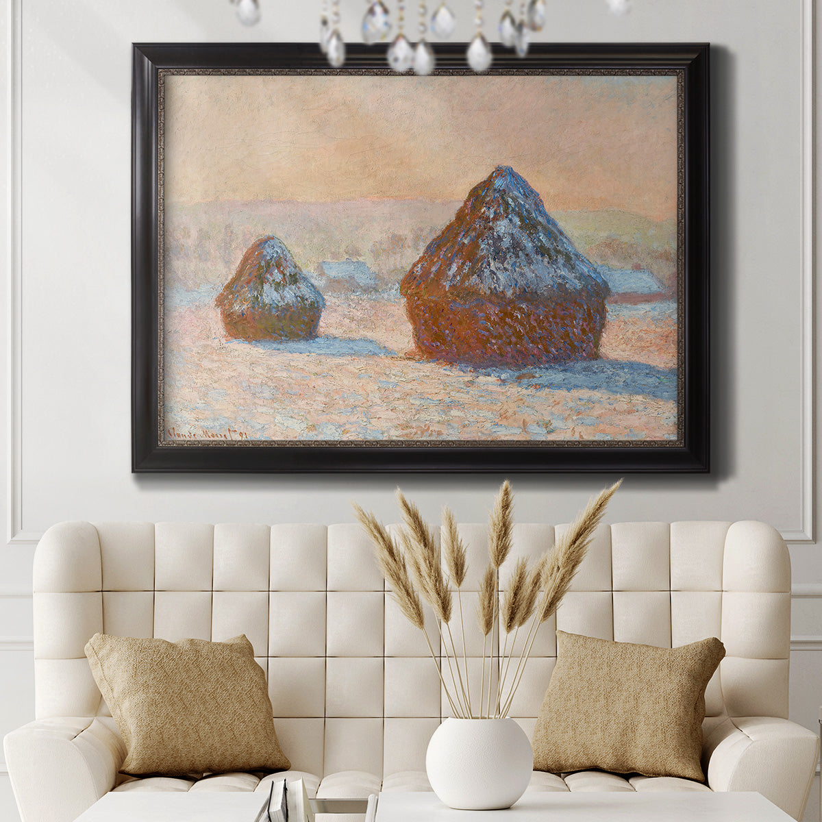 Impressionist winter haystack scene by Claude Monet in an ornate black frame with gilded inner detail displayed in a neutral-toned interior setting.