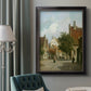 Rustic European street scene painting by Adriaan Eversen in an ornate black frame with gilded inner detail displayed in a neutral interior setting.