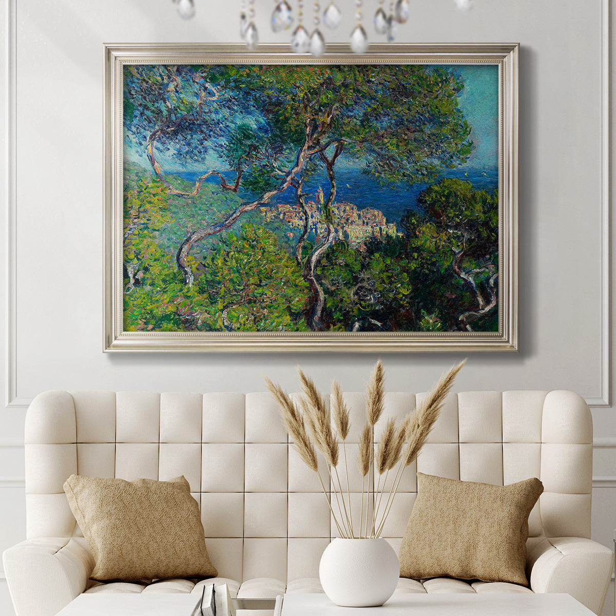 Impressionist Mediterranean coastal landscape by Claude Monet in an ornate champagne frame displayed in a neutral-toned interior setting.