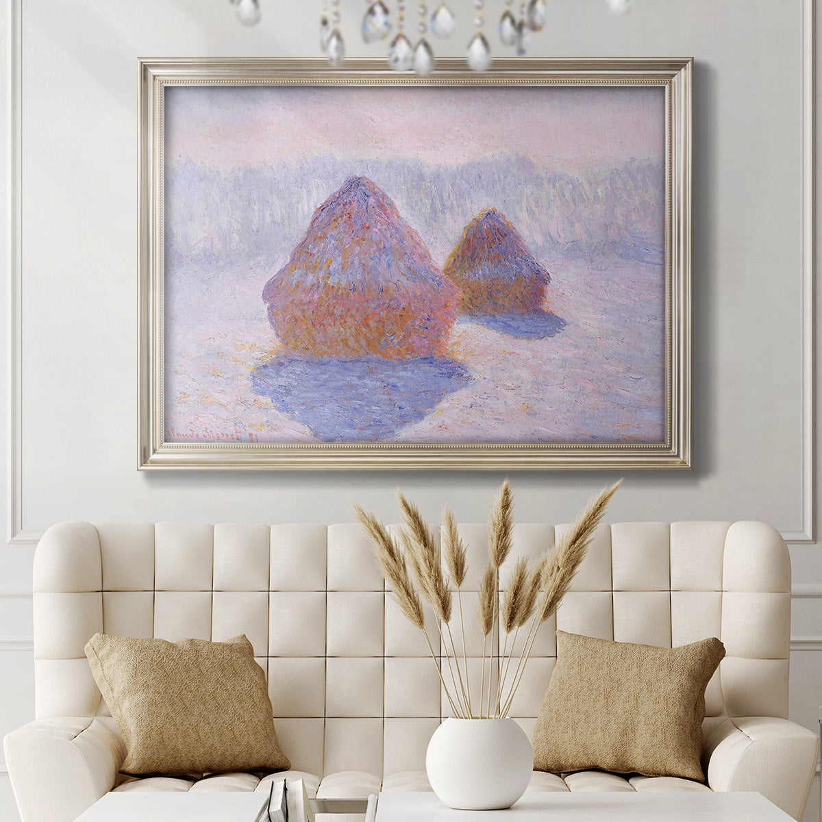 Impressionist winter haystack scene with sunlight by Claude Monet in an ornate champagne frame displayed in a neutral-toned interior setting.