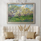 Impressionist spring orchard landscape by Vincent van Gogh in an ornate champagne frame displayed in a neutral-toned interior setting.