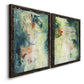 Angled view of a set of two black barnwood framed canvas prints featuring two nature-inspired mixed-media abstracts featuring layered blue green cream and charcoal textures.