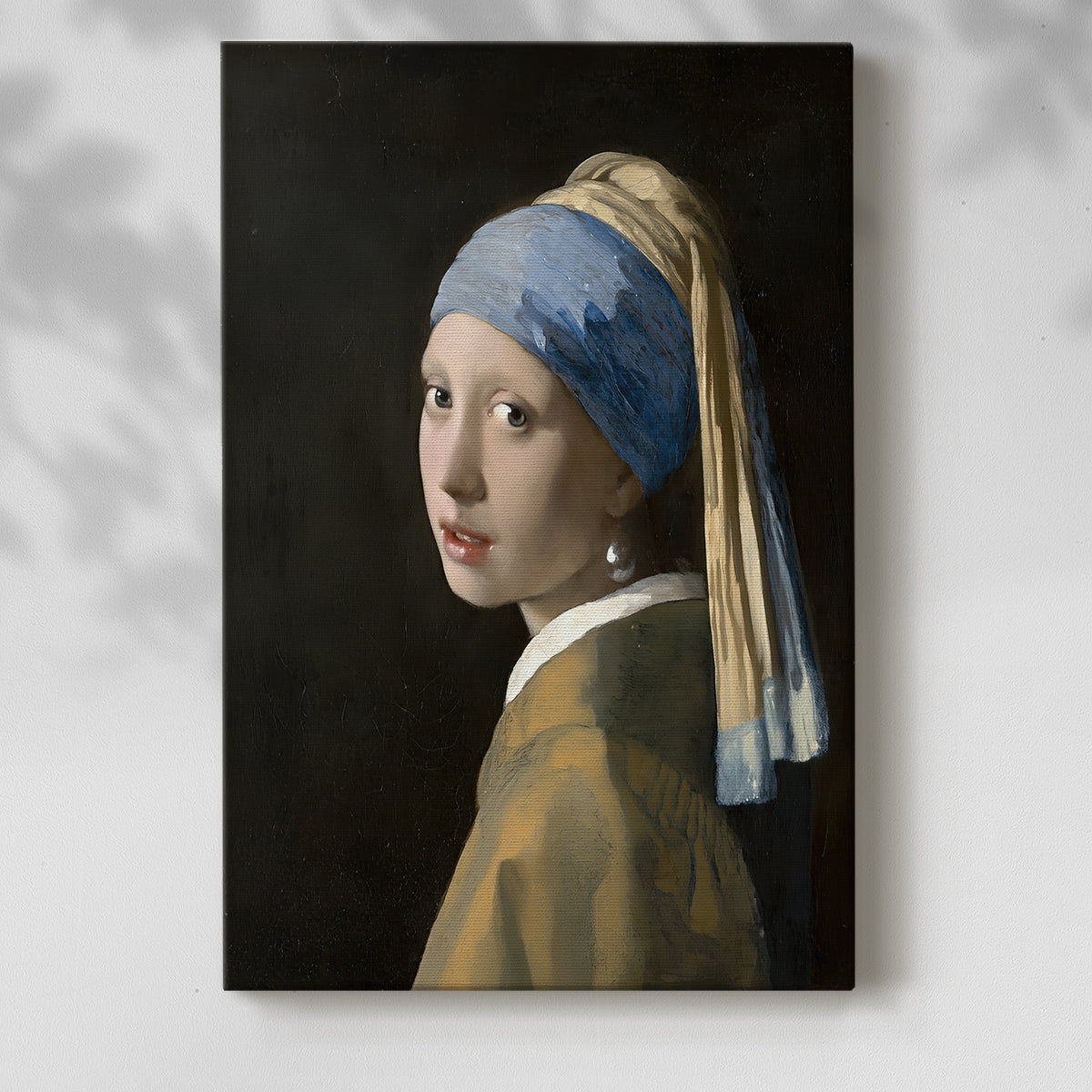 Canvas art print of a close-up figure with dark background and luminous skin tones with a soft shadow on a white background.