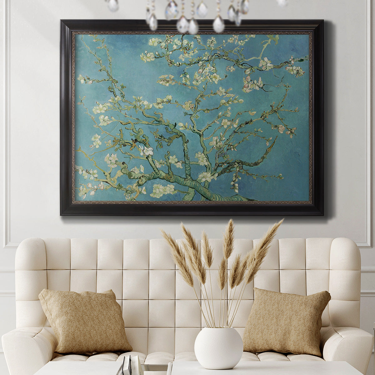 Impressionist flowering almond branch painting by Vincent van Gogh in an ornate black frame with gilded inner detail displayed in a neutral-toned interior setting.