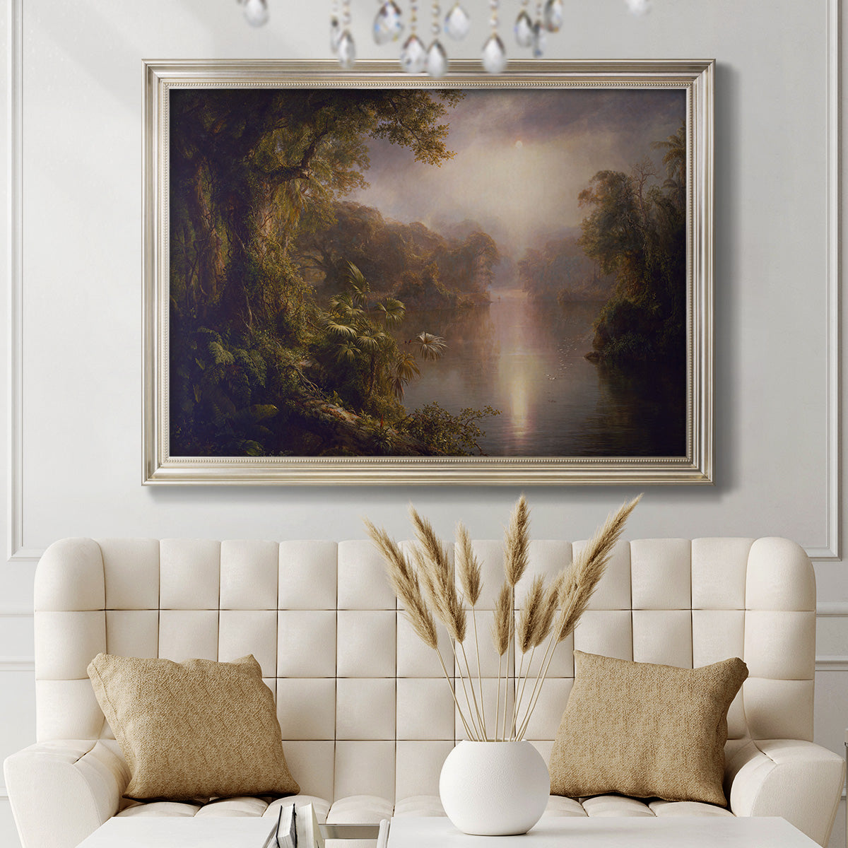 Luminous romantic landscape painting by Frederic Edwin Church in an ornate champagne frame displayed in a neutral-toned interior setting.