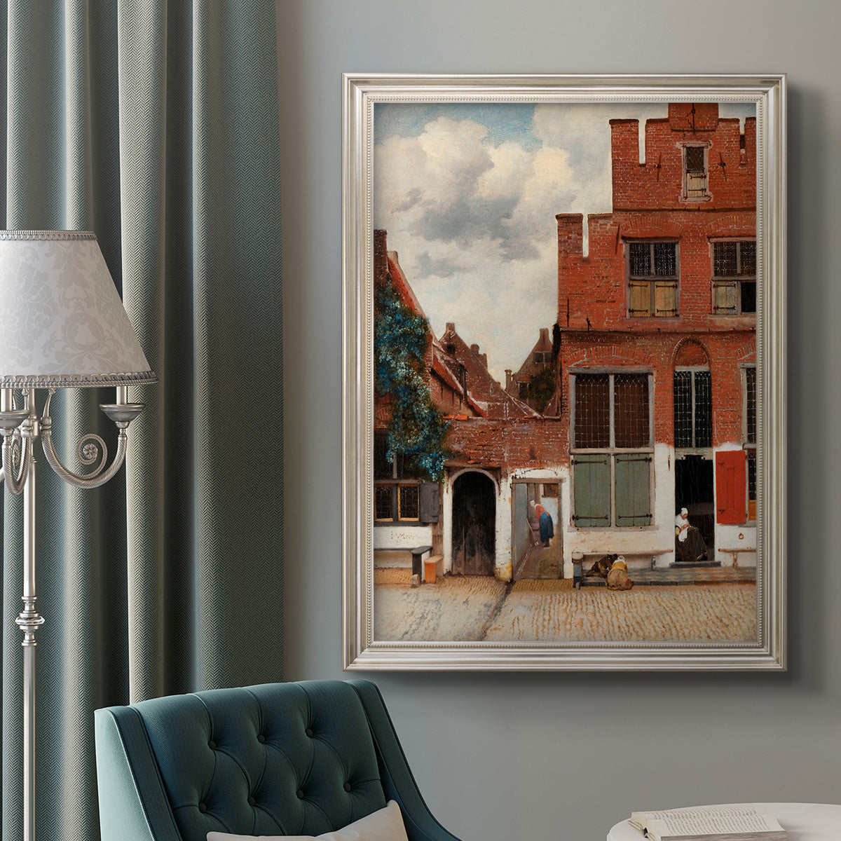 Realist city street scene by Johannes Vermeer in an ornate champagne frame displayed in a neutral interior setting.
