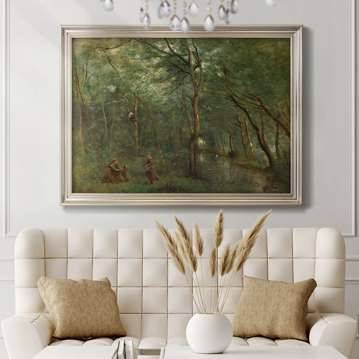 Traditional rural landscape scene with figures by Jean-Baptiste-Camille Corot in an ornate champagne frame displayed in a neutral-toned interior setting.