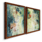 Angled view of a set of two maple barnwood framed canvas prints featuring two nature-inspired mixed-media abstracts featuring layered blue green cream and charcoal textures.