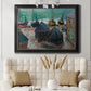 Impressionist coastal beach scene with boats by Claude Monet in an ornate black frame with gilded inner detail displayed in a neutral-toned interior setting.