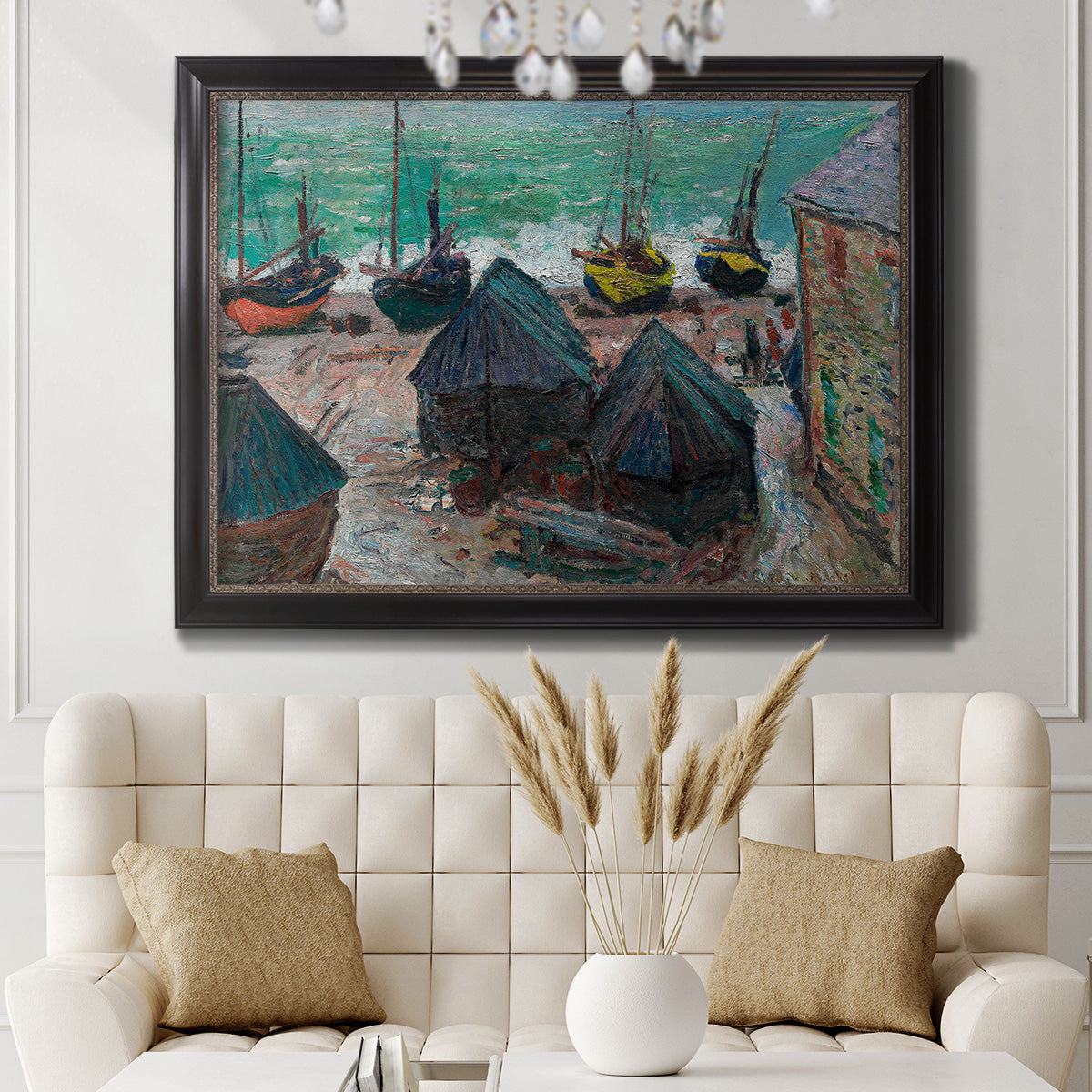 Impressionist coastal beach scene with boats by Claude Monet in an ornate black frame with gilded inner detail displayed in a neutral-toned interior setting.
