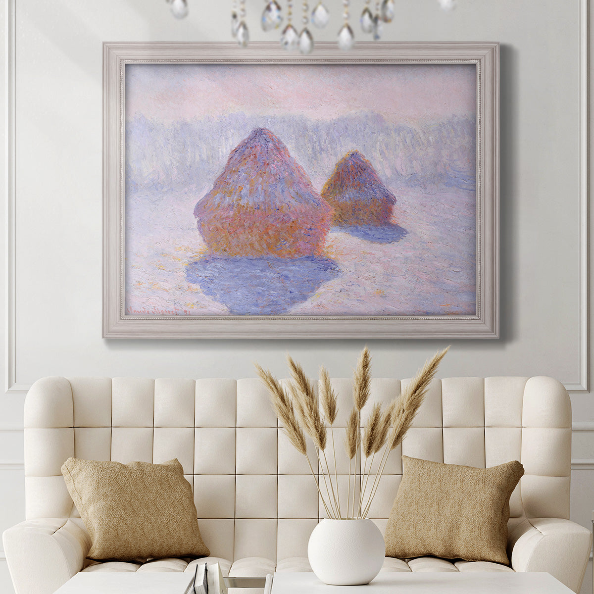Impressionist winter haystack scene with sunlight by Claude Monet in an ornate weathered white frame displayed in a neutral-toned interior setting.