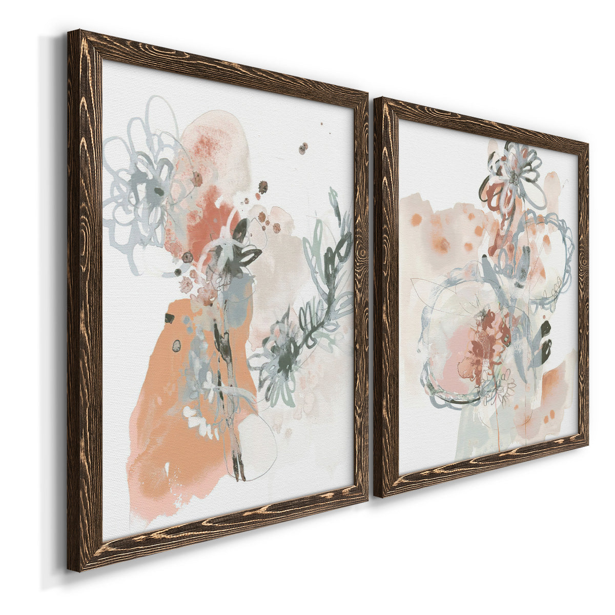 Angled view of a set of two walnut barnwood framed canvas prints featuring two abstract watercolor botanicals featuring loose blush gray and coral floral gestures.