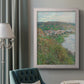 Impressionist landscape view of Vétheuil by Claude Monet in an ornate weathered white frame displayed in a neutral interior setting.