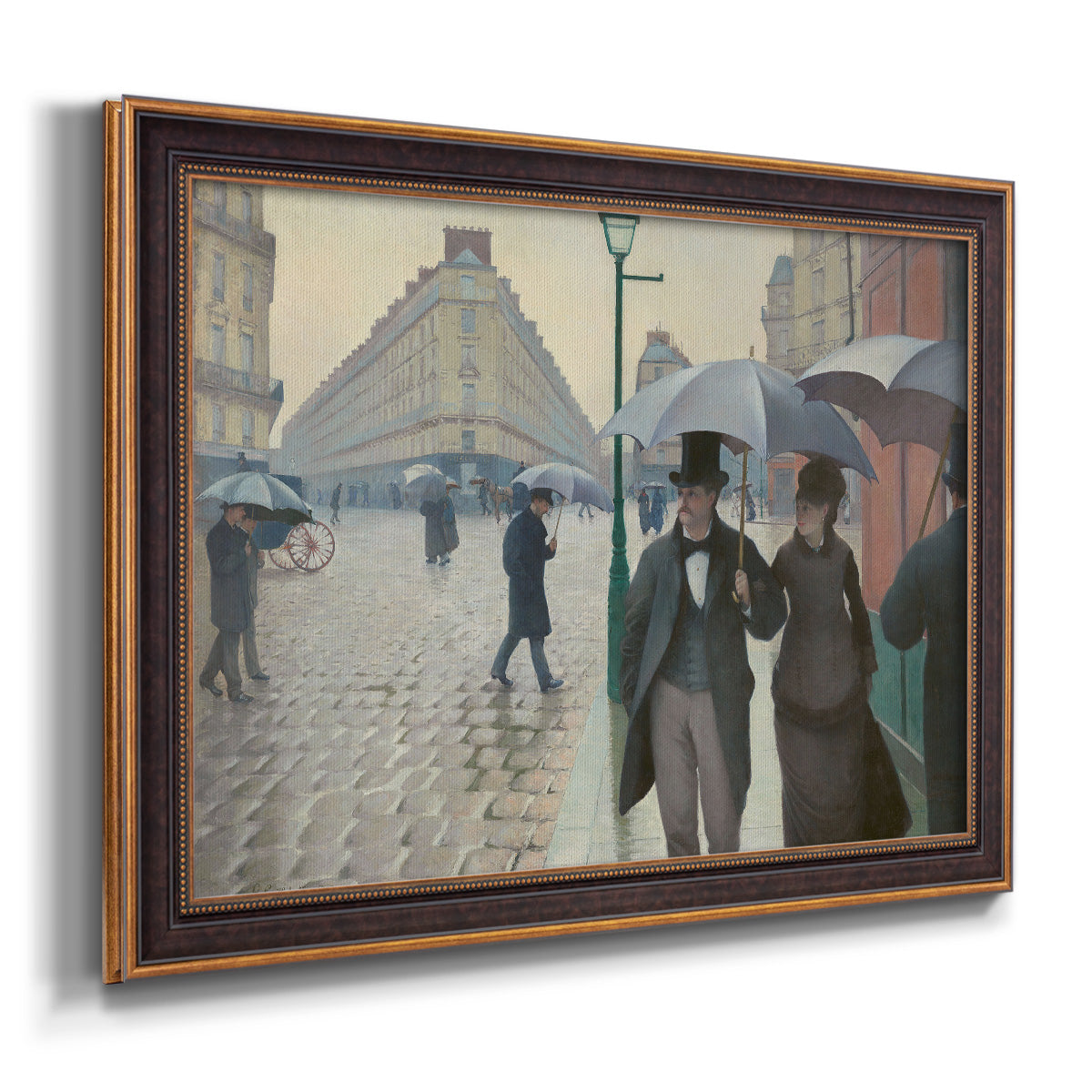 Impressionist urban street scene in the rain by Gustave Caillebotte printed on canvas in an ornate bronzed mahogany wood frame.