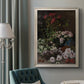 Early impressionist floral painting by Claude Monet in an ornate champagne frame displayed in a neutral interior setting.