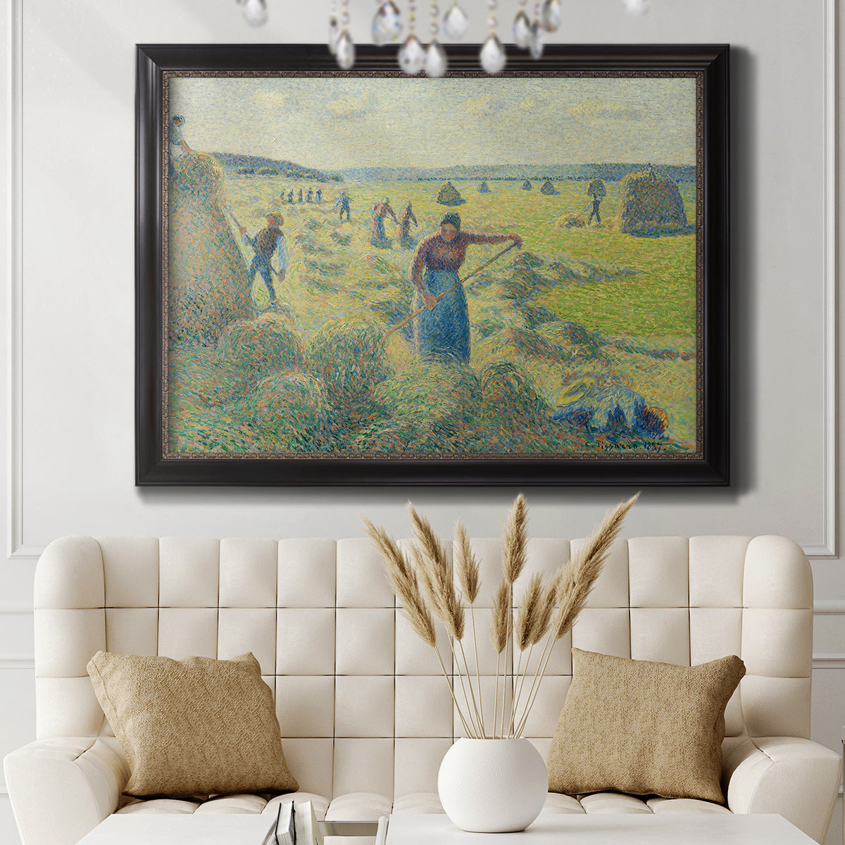 Impressionist rural hay harvest landscape by Camille Pissarro in an ornate black frame with gilded inner detail displayed in a neutral-toned interior setting.