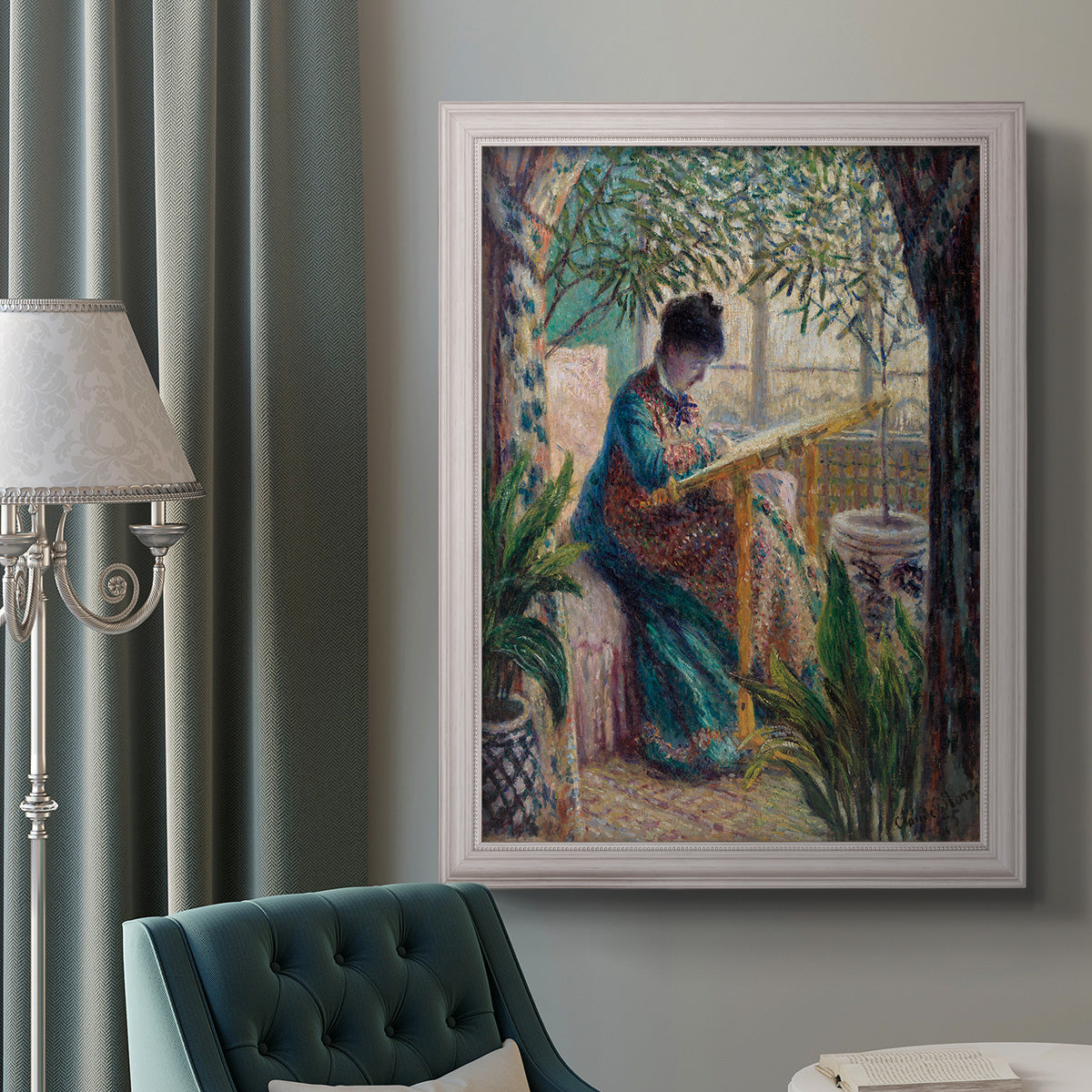 Impressionist portrait of Madame Monet sewing by Claude Monet in an ornate weathered white frame displayed in a neutral interior setting.