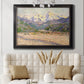 Impressionist valley landscape in southern France by Claude Monet in an ornate black frame with gilded inner detail displayed in a neutral-toned interior setting.