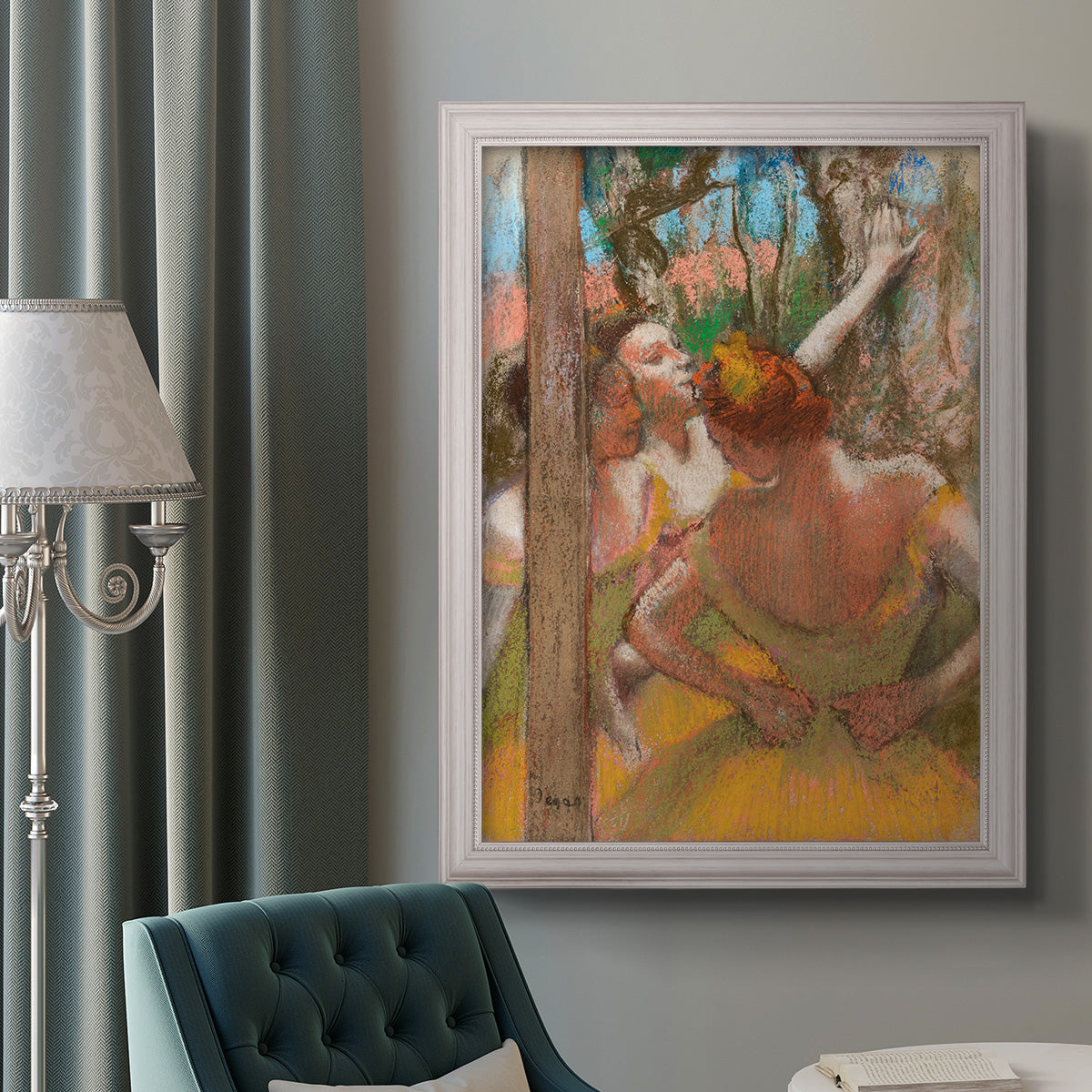 Impressionist ballet dancer composition by Edgar Degas in an ornate weathered white frame displayed in a neutral interior setting.