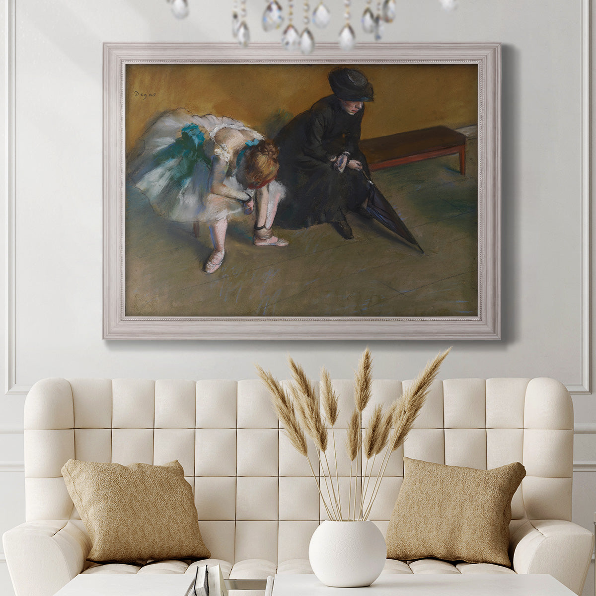 Impressionist portrait of a seated woman by Edgar Degas in an ornate weathered white frame displayed in a neutral-toned interior setting.